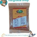 Fenugreek Tea in a cup with fenugreek seeds on a wooden table.