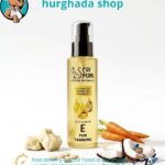 Pearl Essence Elixir Vitamin E tanning oil bottle with coconut, carrot, and sesame oil ingredients